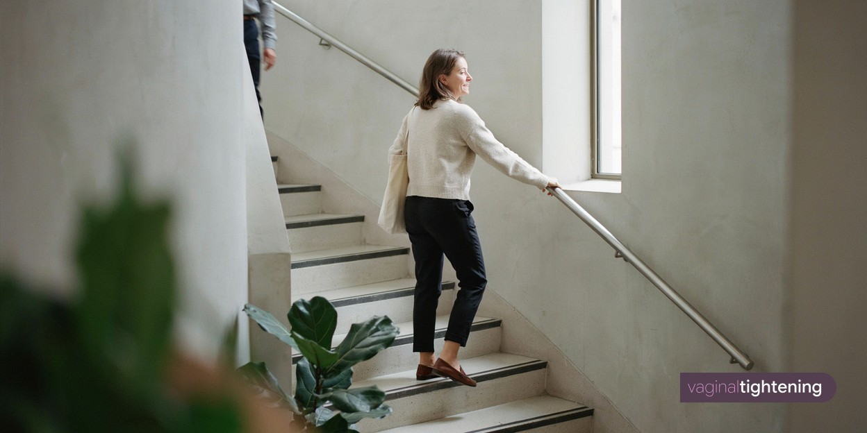 A woman climbing stairs with a shoulder bag